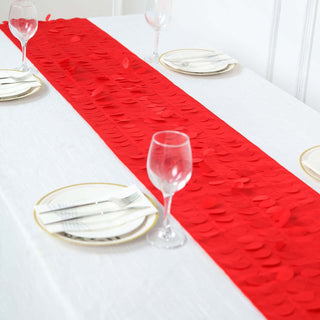 Red table runner with circular embellishments on a dining table setting.