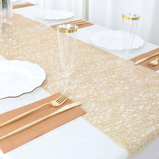 Elegant table runner with gold accents and clear glassware for dining setup.