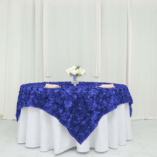 Create Unforgettable Moments with the Royal Blue 3D Rosette Satin Square Table Overlay Create Unforgettable Moments with the Royal Blue 3D Rosette Satin Square Table Overlay