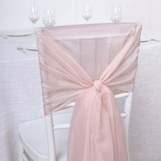 Pink chair sash tied elegantly on a white chair in a dining setup.