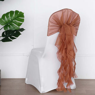 White chair cover with brown organza sash and cascading ribbons