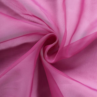 Pink sheer fabric with soft texture and draping appearance.