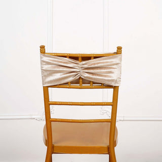 Gold satin chair cover with ruched design on a wooden chair