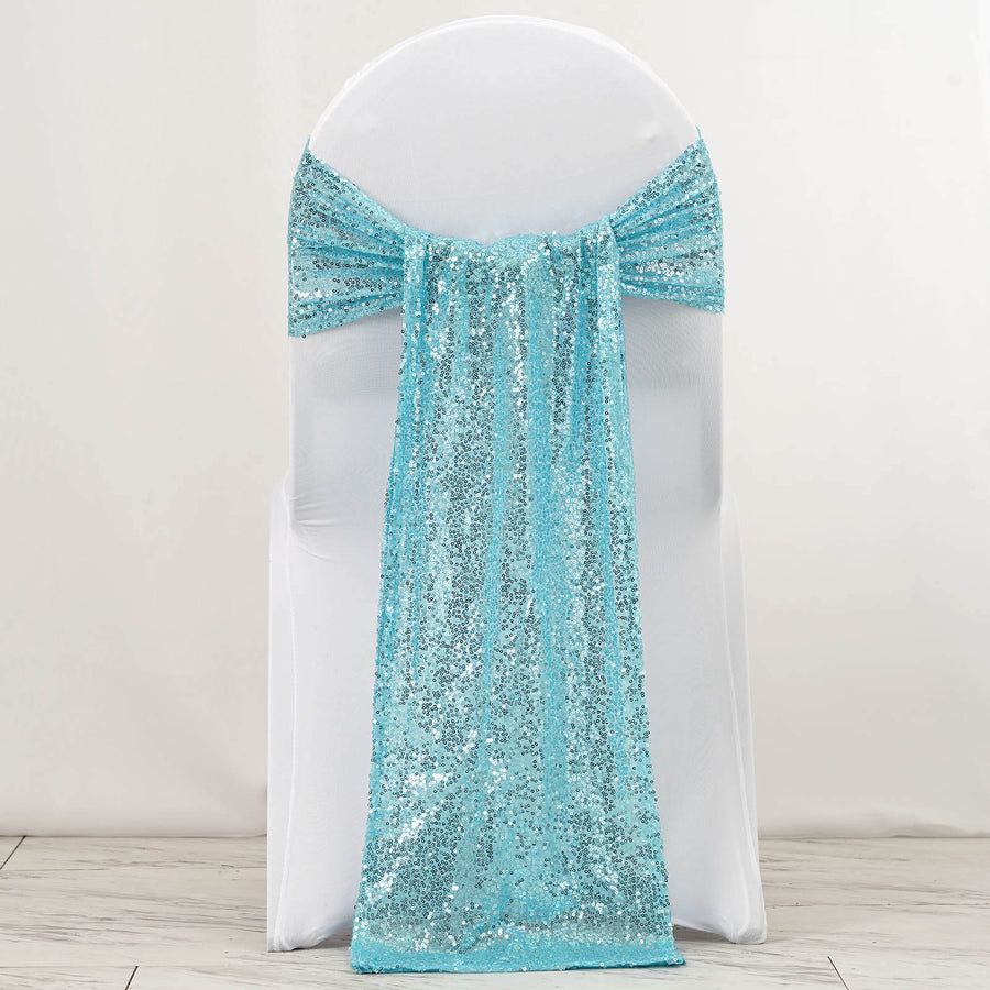 Turquoise sequin chair sash draped over a white chair
