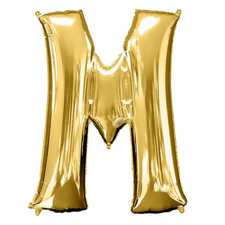 Gold foil letter "M" balloon on a plain white background.
