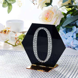 Black hexagon number "0" decor with rhinestones on a table setting.