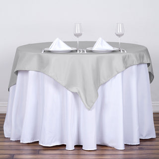 Add Elegance to Your Event with the 54x54 Silver Square Seamless Polyester Table Overlay