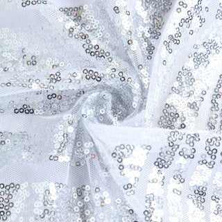 Silver sequin fabric with a sheer white background.