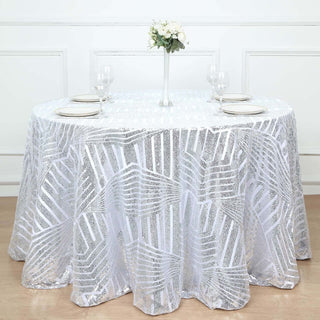 Round silver sequin tablecloth with leaf pattern on a dining table.