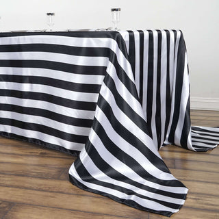 Black and white striped tablecloth draping over a wooden table.
