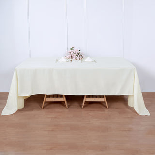 Elevate Your Event Decor with the 60"x126" Ivory Seamless Polyester Rectangular Tablecloth