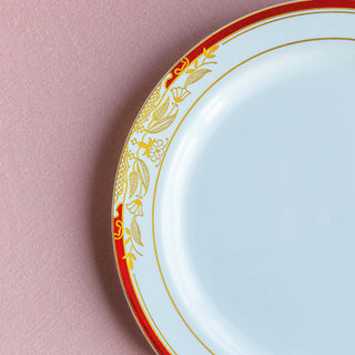 Elegant white plate with gold and red floral rim design.