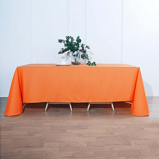 Add Elegance to Your Event with the 90"x132" Orange Seamless Polyester Rectangular Tablecloth Add Elegance to Your Event with the 90"x132" Orange Seamless Polyester Rectangular Tablecloth