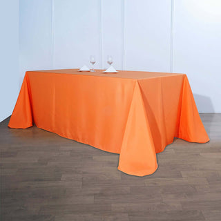Elevate Your Event Decor with the 90"x156" Orange Seamless Polyester Rectangular Tablecloth Elevate Your Event Decor with the 90"x156" Orange Seamless Polyester Rectangular Tablecloth