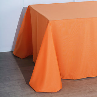 Durable and Stylish: The 90"x156" Orange Seamless Polyester Rectangular Tablecloth