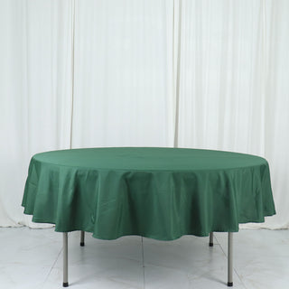 Experience Unmatched Quality with the 90" Hunter Emerald Green Seamless Polyester Round Tablecloth