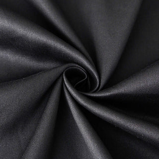 Black fabric texture in a spiral pattern.