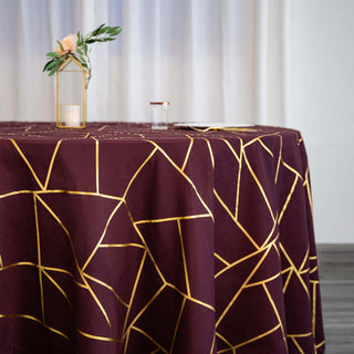 Burgundy tablecloth with gold geometric pattern on a table