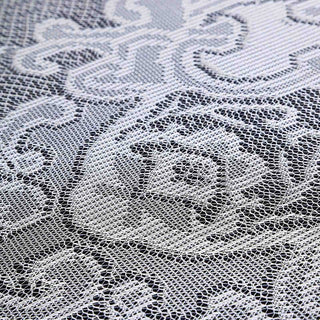Delicate white lace fabric with intricate patterns and textures.