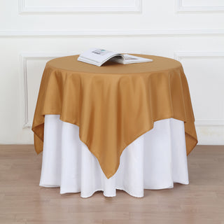 Add Elegance to Your Event with the 54"x54" Gold Square Seamless Polyester Table Overlay