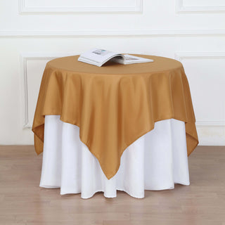 Add Elegance to Your Event with the 54"x54" Gold Square Polyester Table Overlay Add Elegance to Your Event with the 54"x54" Gold Square Polyester Table Overlay