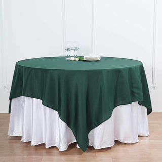 Add Elegance to Your Event with the Hunter Emerald Green Square Polyester Table Overlay Add Elegance to Your Event with the Hunter Emerald Green Square Polyester Table Overlay
