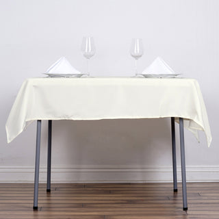 Create a Timeless and Elegant Setting with the Ivory Square Seamless Polyester Table Overlay