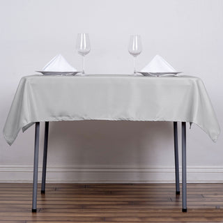 Create a Stunning Table Setting with the 54x54 Silver Square Seamless Polyester Table Overlay