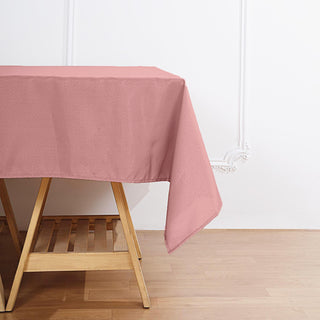 Enhance Your Event Decor with the 70"x70" Dusty Rose Square Seamless Polyester Tablecloth