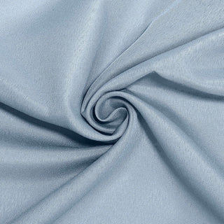 Light blue fabric texture in a spiral pattern.