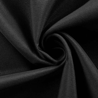 Black fabric texture in a swirling pattern.