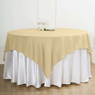 Beige round tablecloth draped over a white table for elegant dining.