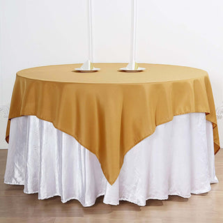 Add Elegance to Your Event with the 70"x70" Gold Square Polyester Table Overlay Add Elegance to Your Event with the 70"x70" Gold Square Polyester Table Overlay