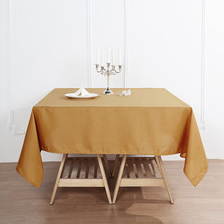 Add Elegance to Your Event with the 70"x70" Gold Square Seamless Polyester Tablecloth