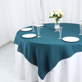 Create a Stunning Table Setting with the Peacock Teal Polyester Square Table Overlay Create a Stunning Table Setting with the Peacock Teal Polyester Square Table Overlay