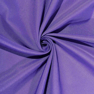 Purple fabric swirl texture on a plain background.