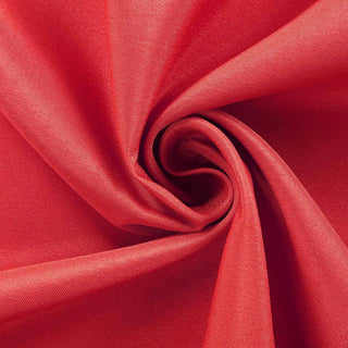 Red fabric texture close-up shot showcasing its smooth and soft surface.