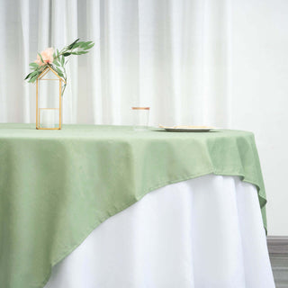 Green tablecloth draped elegantly on a table with decorative elements.