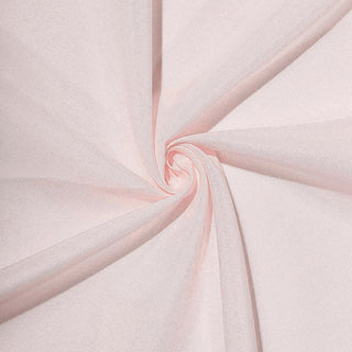 Soft pink fabric swirls, showcasing smooth texture and delicate color.