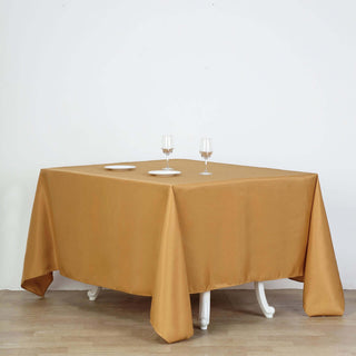 Brown tablecloth draped over a table set with glasses and plates.