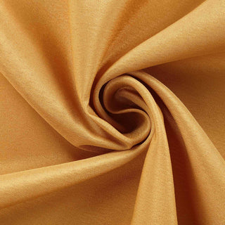 Golden fabric swirl showcasing soft texture and vibrant color.