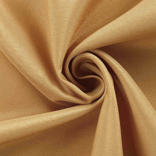 Textured golden fabric in a swirling pattern.