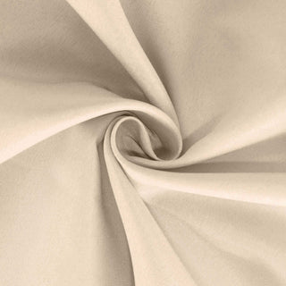 Beige fabric texture in a swirling pattern.