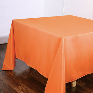 Create a Stunning Table Setup with the 90x90 Orange Seamless Square Polyester Table Overlay