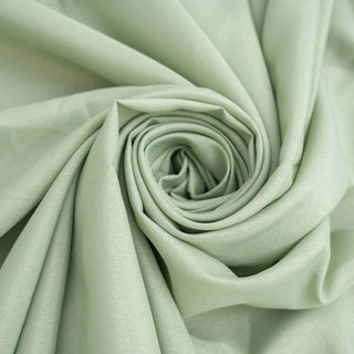 Soft green fabric in a rolled spiral pattern.