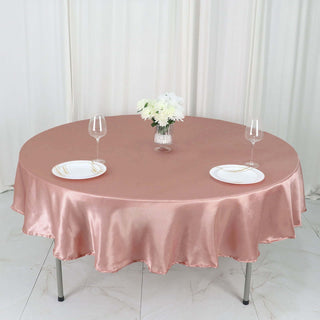 Add Elegance to Your Event with the 90" Dusty Rose Satin Round Tablecloth Add Elegance to Your Event with the 90" Dusty Rose Satin Round Tablecloth