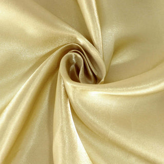 Gold satin fabric with a smooth, shiny texture.