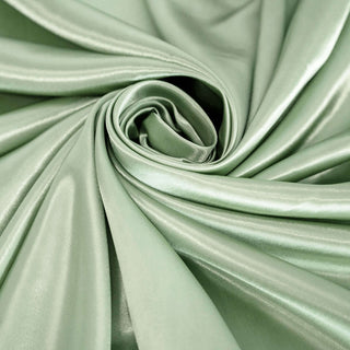 Soft green satin fabric in a swirling design.