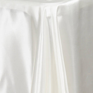 White satin fabric draped elegantly, showcasing its smooth texture and sheen.
