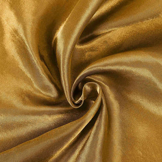 Gold satin fabric with a smooth, shiny texture.